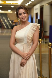Nivetha Pethuraj in a shoulderless dress posing for photos