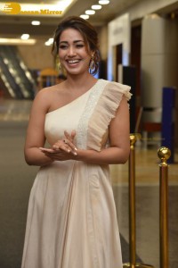 Nivetha Pethuraj in a shoulderless dress posing for photos