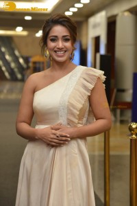 Nivetha Pethuraj in a shoulderless dress posing for photos