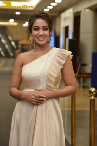 Nivetha Pethuraj in a shoulderless dress posing for photos