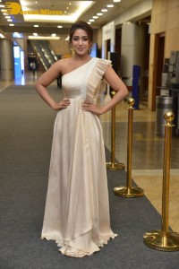 Nivetha Pethuraj in a shoulderless dress posing for photos