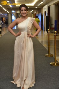 Nivetha Pethuraj in a shoulderless dress posing for photos