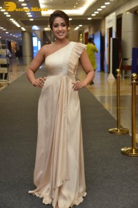 Nivetha Pethuraj in a shoulderless dress posing for photos