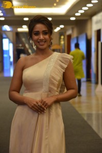 Nivetha Pethuraj in a shoulderless dress posing for photos