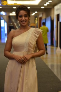 Nivetha Pethuraj in a shoulderless dress posing for photos