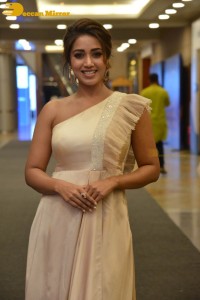 Nivetha Pethuraj in a shoulderless dress posing for photos