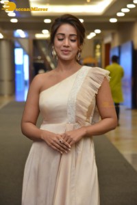 Nivetha Pethuraj in a shoulderless dress posing for photos