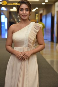 Nivetha Pethuraj in a shoulderless dress posing for photos