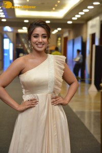 Nivetha Pethuraj in a shoulderless dress posing for photos