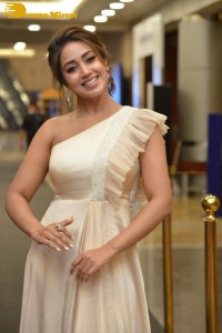 Nivetha Pethuraj in a shoulderless dress posing for photos