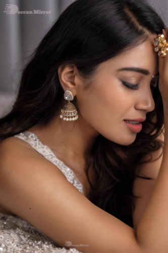 Tamil and Telugu Actress Nivetha Pethuraj is seen in a white dress in this photoshoot