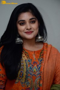 Actress Nivetha Thomas in a orange salwar dress