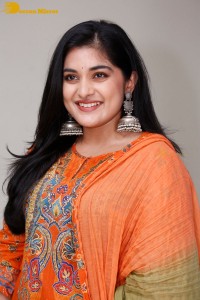 Actress Nivetha Thomas in a orange salwar dress