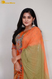 Actress Nivetha Thomas in a orange salwar dress