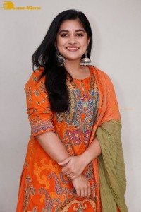 Actress Nivetha Thomas in a orange salwar dress
