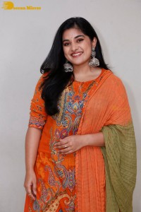 Actress Nivetha Thomas in a orange salwar dress