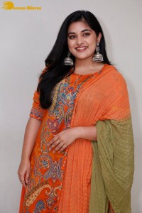 Actress Nivetha Thomas in a orange salwar dress