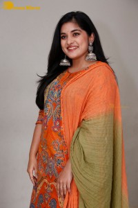 Actress Nivetha Thomas in a orange salwar dress