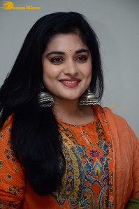 Actress Nivetha Thomas in a orange salwar dress