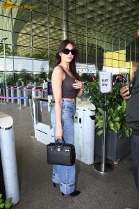 bollywood actress Nora Fatehi cute in a brown top and blue jeans at mumbai airport
