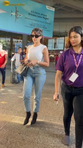 Actress Nora Fatehi in a white top and denim jeans at airport