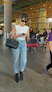 Actress Nora Fatehi in a white top and denim jeans at airport