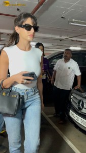 Actress Nora Fatehi in a white top and denim jeans at airport