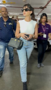 Actress Nora Fatehi in a white top and denim jeans at airport