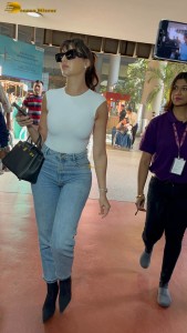 Actress Nora Fatehi in a white top and denim jeans at airport