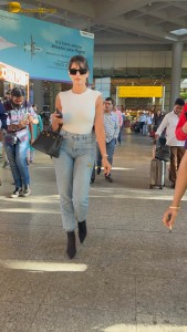Actress Nora Fatehi in a white top and denim jeans at airport