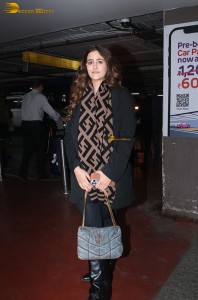 actress Nupur Sanon in a black coat and shawl spotted at mumbai airport