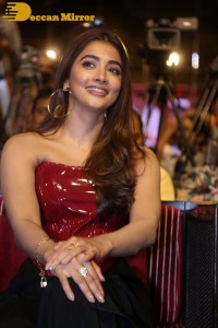Pooje Hegde in a red shoulderless top and black pants while attending a movie funciton
