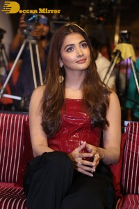 Pooje Hegde in a red shoulderless top and black pants while attending a movie funciton