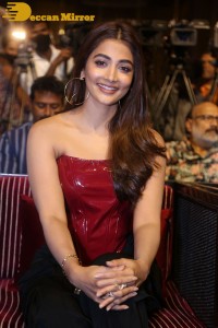 Pooje Hegde in a red shoulderless top and black pants while attending a movie funciton
