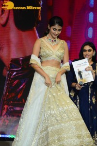 Pooja Hegde in a white and gold lehenga choli dress