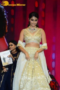 Pooja Hegde in a white and gold lehenga choli dress