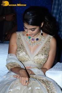 Pooja Hegde in a white and gold lehenga choli dress