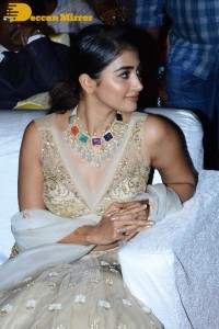 Pooja Hegde in a white and gold lehenga choli dress