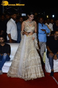 Pooja Hegde in a white and gold lehenga choli dress