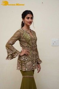 Pooja Hegde in a dark green dress