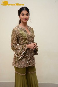 Pooja Hegde in a dark green dress