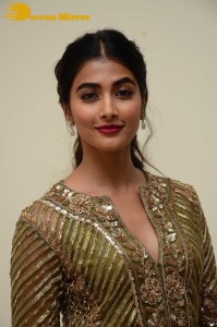 Pooja Hegde in a dark green dress