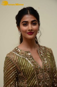 Pooja Hegde in a dark green dress