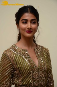 Pooja Hegde in a dark green dress