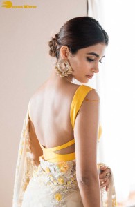 Pooja Hegde in a light yellow saree