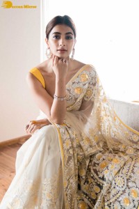 Pooja Hegde in a light yellow saree