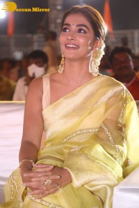 Actress Pooja Hegde in a yellow saree while attending the pre-release event of the Telugu movie Acharya