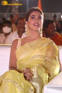Actress Pooja Hegde in a yellow saree while attending the pre-release event of the Telugu movie Acharya