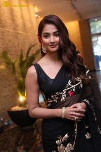 Pooja Hegde in a black saree while attending Acharya movie press meet