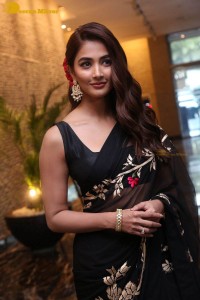 Pooja Hegde in a black saree while attending Acharya movie press meet